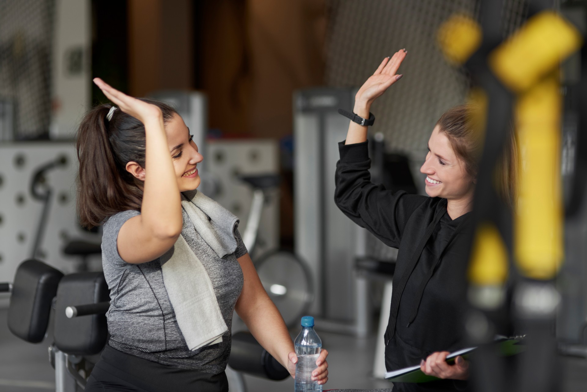 Sporty couple high five at gym