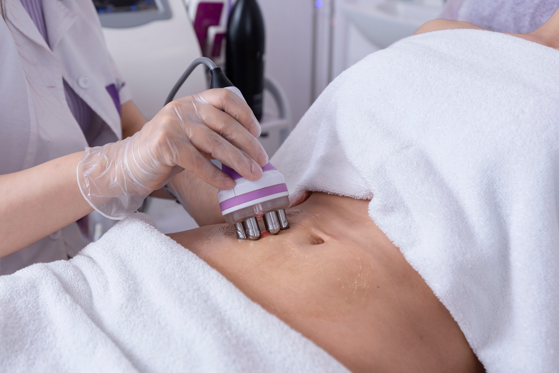 Radiofrequency body treatment of abdomen ,Non-surgical body sculpting. Anti-cellulite and anti-fat therapy in beauty salon. Cosmetology treatment of overweight and flaccidity